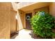 Welcoming front entrance with a security door, a wreath, and lush green landscaping at 9502 W Mcrae Way, Peoria, AZ 85382