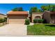 Charming home featuring a two-car garage, desert landscaping, and a classic red tile roof at 9502 W Mcrae Way, Peoria, AZ 85382