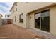 Backyard showing the exterior wall and a sliding glass door at 15598 S 181St Dr, Goodyear, AZ 85338