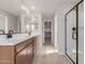 Bathroom featuring double sinks, undermount lighting, and a large glass shower at 15598 S 181St Dr, Goodyear, AZ 85338