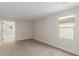 Bedroom with neutral carpet, base trim, electrical outlets and switch, and a window at 15598 S 181St Dr, Goodyear, AZ 85338