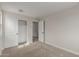 Bedroom with closet featuring a closet, doors, and carpet at 15598 S 181St Dr, Goodyear, AZ 85338