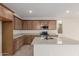 Beautiful kitchen with granite countertops, stainless steel appliances, and wood cabinets at 15598 S 181St Dr, Goodyear, AZ 85338