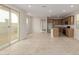 Open-concept living space showcases ceramic tile, abundant natural light, and view into the kitchen at 15598 S 181St Dr, Goodyear, AZ 85338