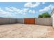 Large backyard with block wall and wooden gate at 3810 N Mateo Dr, Eloy, AZ 85131