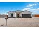 New construction home with a two-car garage and landscaped front yard at 3810 N Mateo Dr, Eloy, AZ 85131