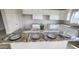 Modern kitchen features granite countertops, white cabinets and is staged with place settings for a formal dinner at 3810 N Mateo Dr, Eloy, AZ 85131