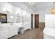 Spa-like bathroom with double vanities, a large soaking tub, and stylish fixtures at 10746 E Whitethorn Dr, Scottsdale, AZ 85262