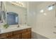 Bathroom with tub, shower, vanity with wood cabinets and mirror at 1718 W Colter St # 195, Phoenix, AZ 85015