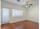 Bedroom with wood flooring, ceiling fan, and private balcony access at 1718 W Colter St # 195, Phoenix, AZ 85015