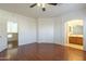 Bedroom with wood floors, ceiling fan and access to bathroom at 1718 W Colter St # 195, Phoenix, AZ 85015