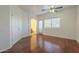 Bright bedroom with wood flooring, ceiling fan, and access to bathroom at 1718 W Colter St # 195, Phoenix, AZ 85015