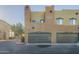 Two-story building with brown garages and desert landscaping at 1718 W Colter St # 195, Phoenix, AZ 85015