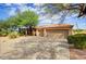 Beautiful home exterior with three-car garage and desert landscaping at 10914 E Cinder Cone Trl, Scottsdale, AZ 85262