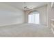 Bright and airy living room featuring neutral carpeting and large window at 10914 E Cinder Cone Trl, Scottsdale, AZ 85262