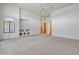 Open living room with built-in shelving and neutral carpeting at 10914 E Cinder Cone Trl, Scottsdale, AZ 85262