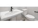 This half bathroom features a pedestal sink and a toilet at 14189 W Sand Hills Rd, Surprise, AZ 85387