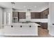 Modern kitchen with stainless steel appliances, white countertops, and dark cabinetry at 14189 W Sand Hills Rd, Surprise, AZ 85387