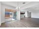 Open-concept living room with hardwood floors, recessed lighting, and a sliding glass door to the backyard at 14189 W Sand Hills Rd, Surprise, AZ 85387