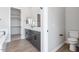 Modern main bathroom featuring a walk-in closet, and a sleek vanity at 14189 W Sand Hills Rd, Surprise, AZ 85387