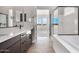 Beautiful main bathroom featuring double vanity, glass shower, and soaking tub at 14189 W Sand Hills Rd, Surprise, AZ 85387