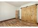 Bedroom with wood flooring and barn doors at 28301 N 154Th St, Scottsdale, AZ 85262