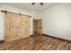 Bedroom with wood flooring and barn doors at 28301 N 154Th St, Scottsdale, AZ 85262