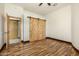 Bedroom with wood flooring and barn doors at 28301 N 154Th St, Scottsdale, AZ 85262