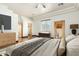 Bright bedroom featuring a king-size bed and wood flooring at 28301 N 154Th St, Scottsdale, AZ 85262