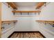 Large walk-in closet with wood shelves and rods at 28301 N 154Th St, Scottsdale, AZ 85262