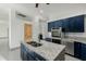 Modern kitchen with blue cabinets, granite island, and stainless steel appliances at 28301 N 154Th St, Scottsdale, AZ 85262