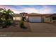 One-story home with tile roof, two-car garage, and desert landscaping at 15713 W Star View Ln, Surprise, AZ 85374