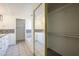 Bright bathroom with tiled floors, white cabinets, and a shower/tub combo at 5249 E Hobart St, Mesa, AZ 85205