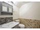 Neatly arranged half bath with modern fixtures, vanity, and attractive stone accent wall at 5249 E Hobart St, Mesa, AZ 85205