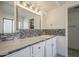 Bathroom features a large mirror with decorative tile backsplash and white cabinets at 5249 E Hobart St, Mesa, AZ 85205