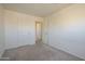 Bedroom with carpet, a closet and an open door leading to the hallway at 5249 E Hobart St, Mesa, AZ 85205