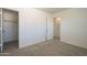 Neutral bedroom with carpet and an open door leading to the hallway and closet at 5249 E Hobart St, Mesa, AZ 85205