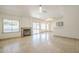 Spacious living room featuring tile floors, a fireplace, and windows at 5249 E Hobart St, Mesa, AZ 85205