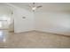 Bright and airy living room featuring tile flooring and a modern ceiling fan at 5249 E Hobart St, Mesa, AZ 85205