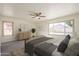 Cozy main bedroom with carpet, ceiling fan, and two windows at 5249 E Hobart St, Mesa, AZ 85205