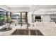 Modern kitchen featuring marble countertops, stainless steel sink, and an adjacent dining area and living room at 7151 E Rancho Vista Dr # 5001, Scottsdale, AZ 85251