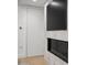 Close-up of modern fireplace with flatscreen, door, and hardwood floors at 7151 E Rancho Vista Dr # 5001, Scottsdale, AZ 85251