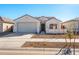 Single-story home with a two-car garage and desert landscaping at 17825 W Encinas Ln, Goodyear, AZ 85338