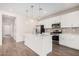 Modern kitchen with white cabinets, island, and stainless steel appliances at 17842 W Blue Sky Dr, Surprise, AZ 85387