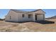 Exterior rear view of a single-story home featuring a covered patio and desert landscape at 38720 W Sherman St, Tonopah, AZ 85354