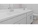 Bathroom with a white double sink vanity, white countertop, and modern fixtures at 7620 W Minton St, Laveen, AZ 85339