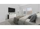 Bright bedroom with a large window, TV, and a dresser at 7620 W Minton St, Laveen, AZ 85339