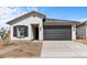 Charming single-story home showcasing a clean white stucco exterior and a two-car garage at 7620 W Minton St, Laveen, AZ 85339