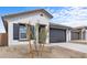 Stylish single-story home with neutral stucco, dark accents, and well-maintained landscaping at 7620 W Minton St, Laveen, AZ 85339