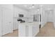 Well-appointed kitchen featuring white cabinetry, stainless steel appliances, and pendant lighting at 7620 W Minton St, Laveen, AZ 85339